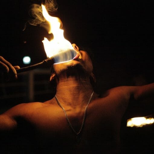 man playing fire in dim light